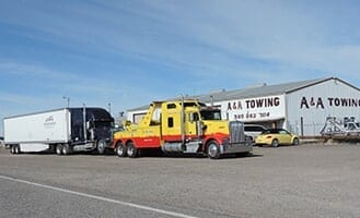 A&A Towing heavy-duty tow truck transporting a large vehicle